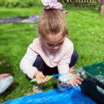 little girl painting jar